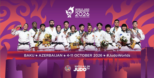 A group of judoka in white uniforms stand with medals, trophies and flowers against a purple and orange graphic backdrop.